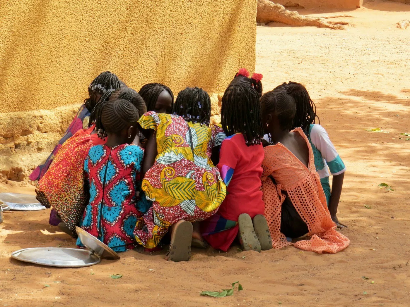 African children sitting on the ground in an outdoor learning session