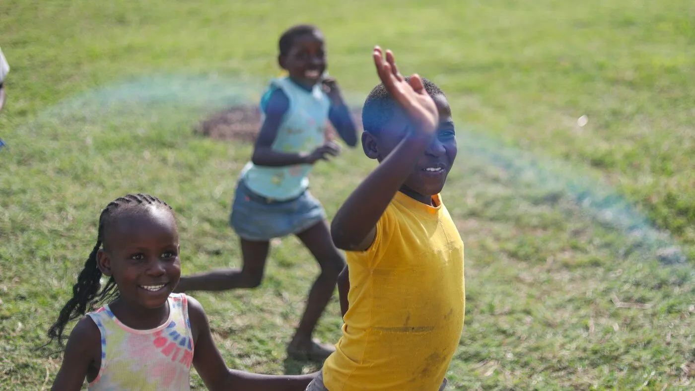 African children running and playing outside a Kenyan school