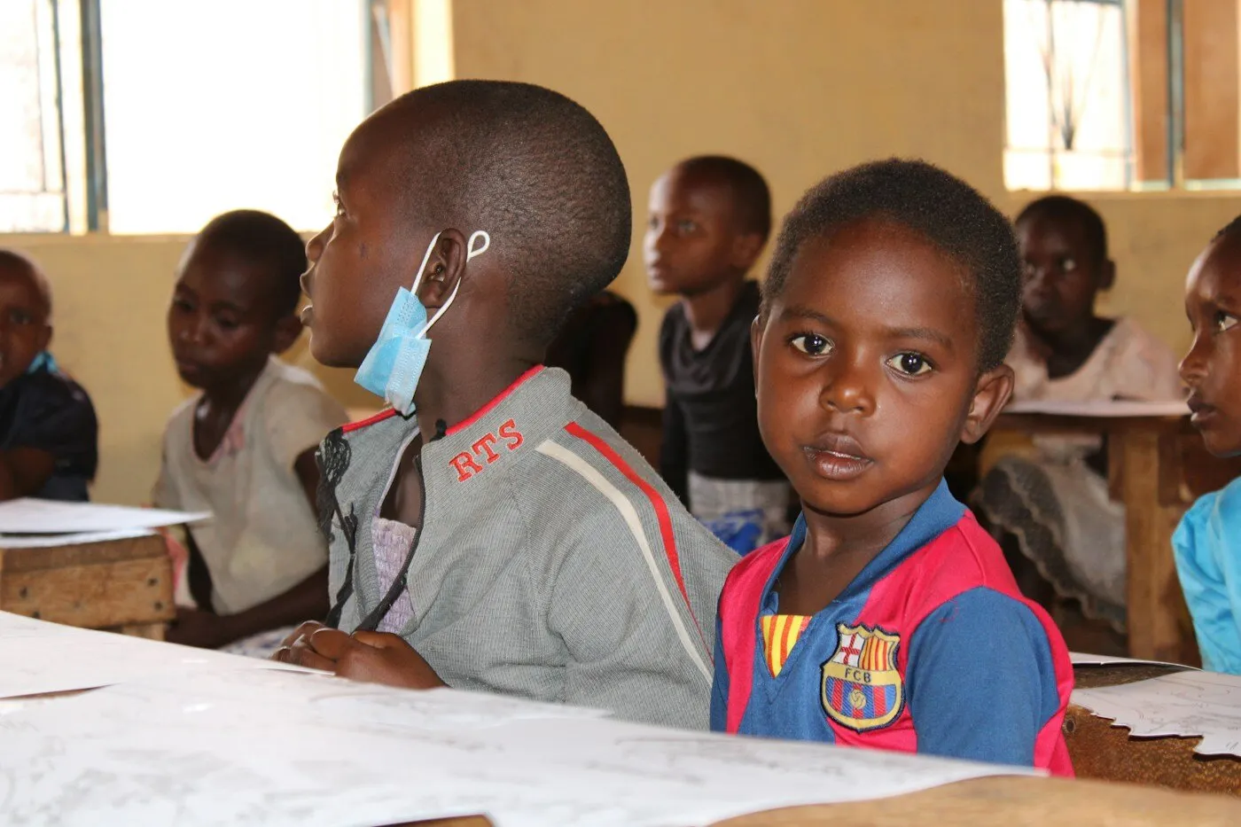 African children sitting at desks in a Kenyan classroom