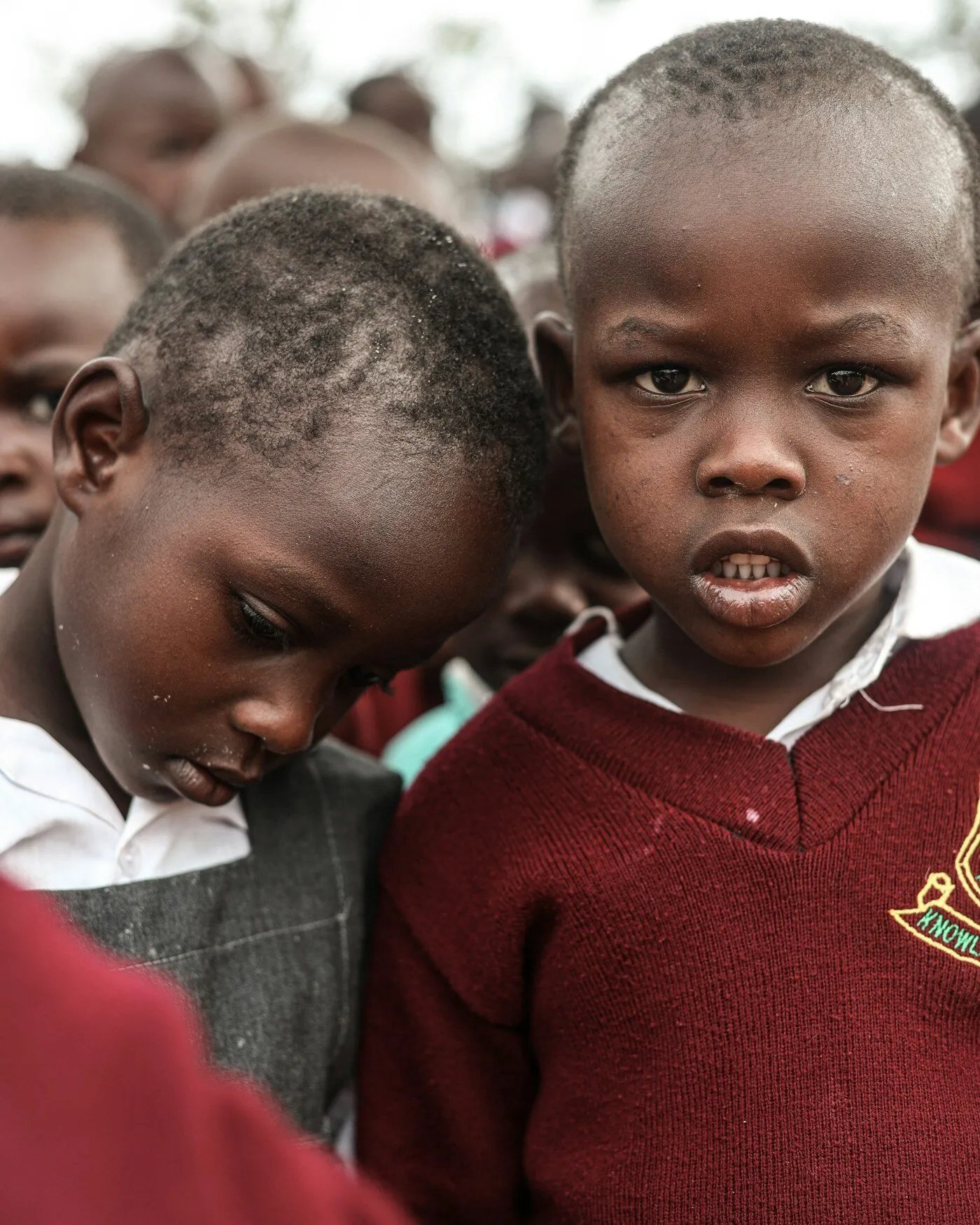 African children in a medium shot outside a school in Kenya