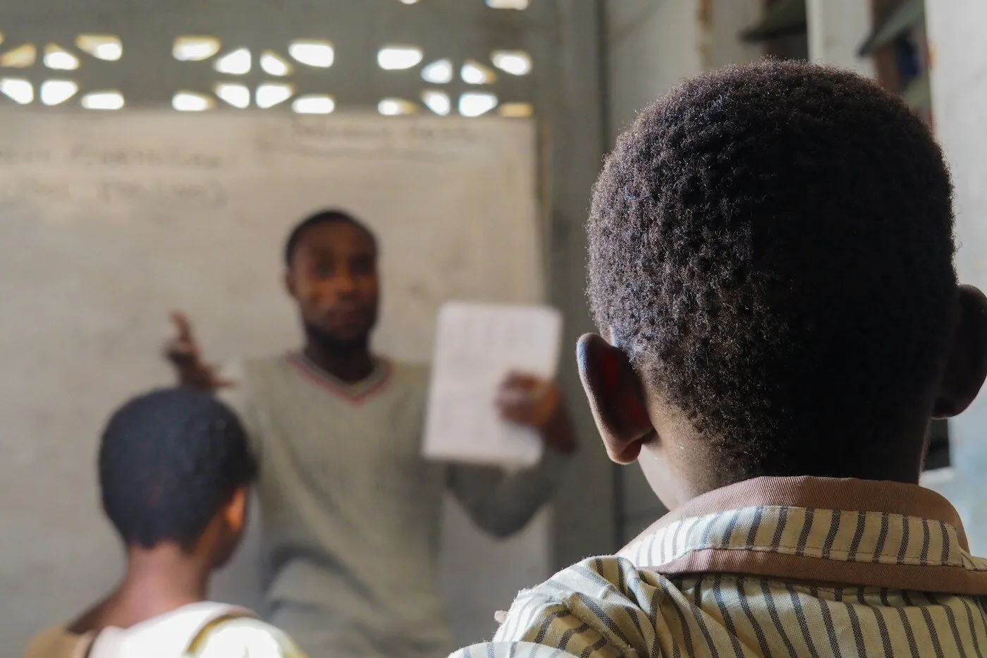 African teacher instructing students in a classroom in Kenya