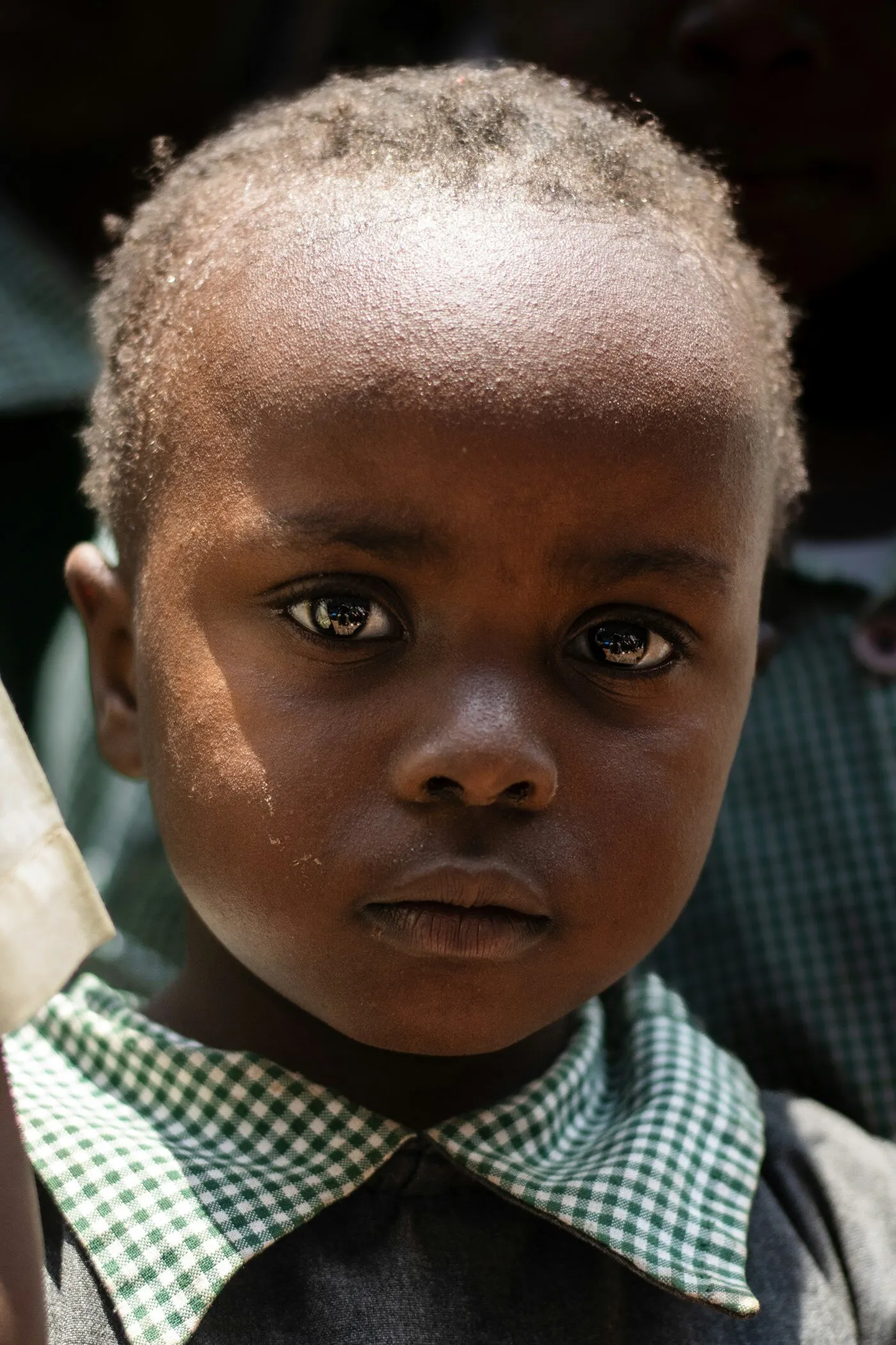 African young boy holding something in Kenya