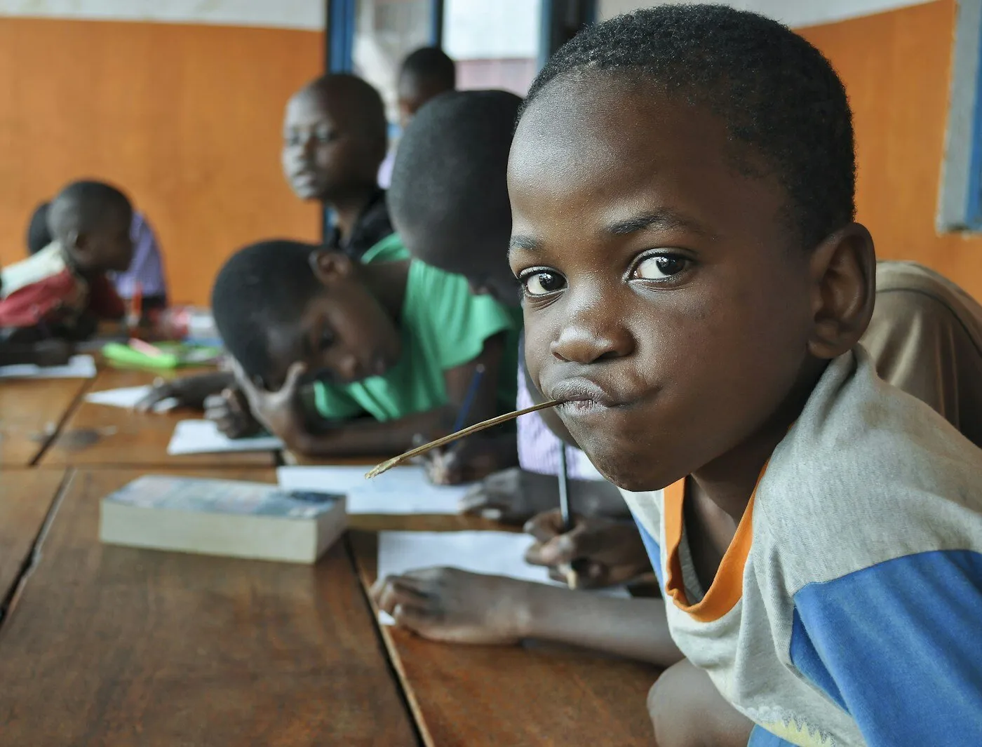 African children sitting at a table in a classroom