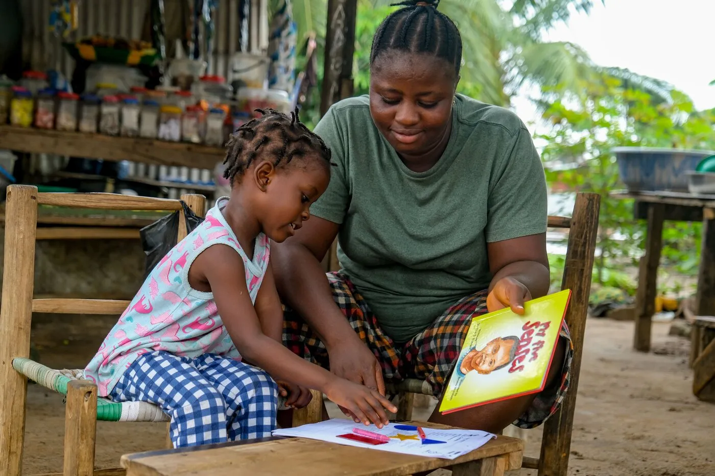 A parent and child reviewing a school report card together